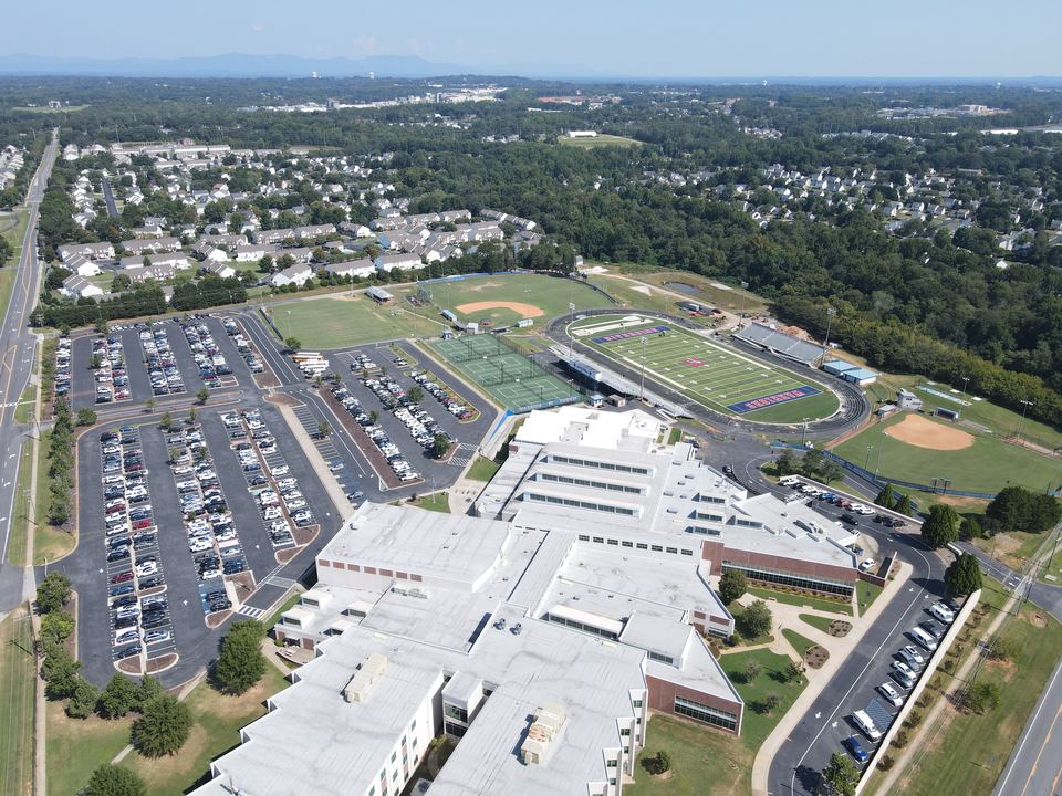 Aerial view of a Greenville County high school campus and the parking lots Dillard Construction Group repaved, sealcoated and striped.